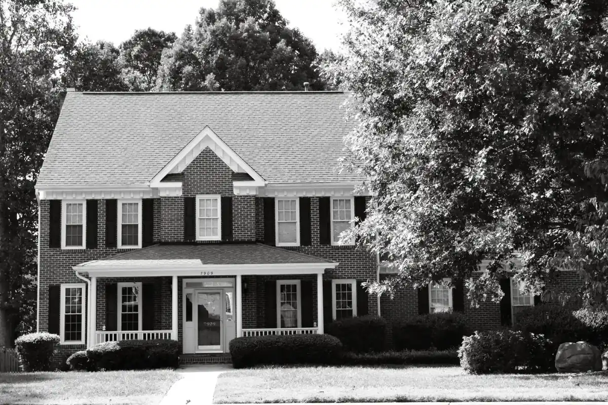 Suburban colonial house with a landscaped yard
