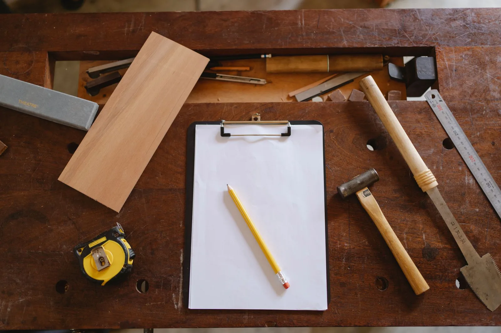 Tape measure and carpenter's pencil on a work surface