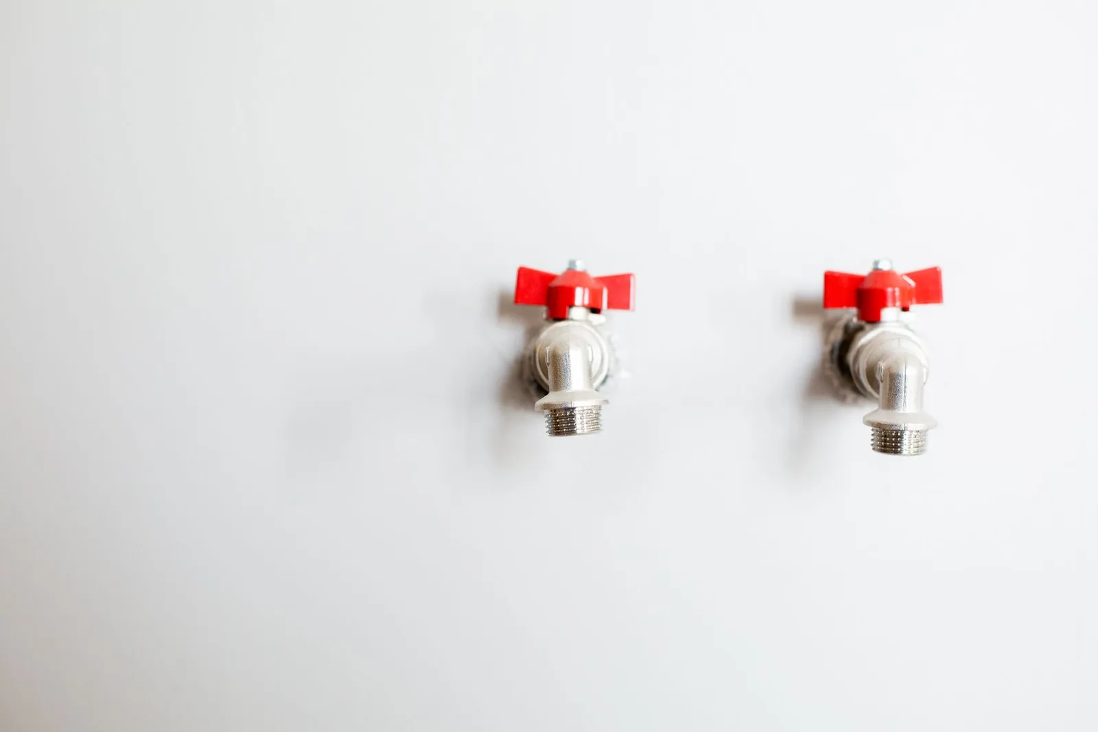 Copper supply lines and shutoff valves under a kitchen sink